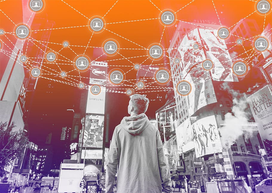 Man surrounded by tall buildings and a chain of services floating above him